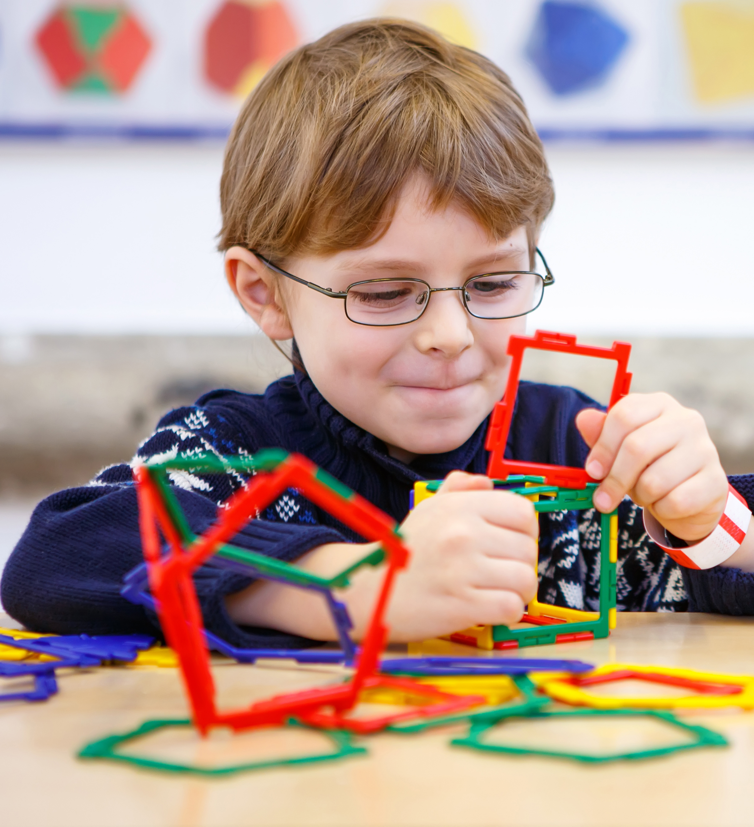 Little Child Playing With Lots Of Colorful Plastic Blocks
